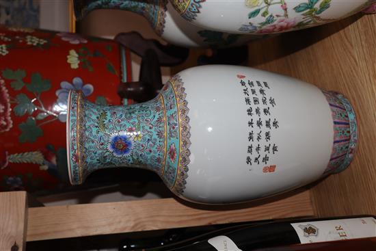 A pair of Chinese famille rose vases and another similar (3) Height 36cm